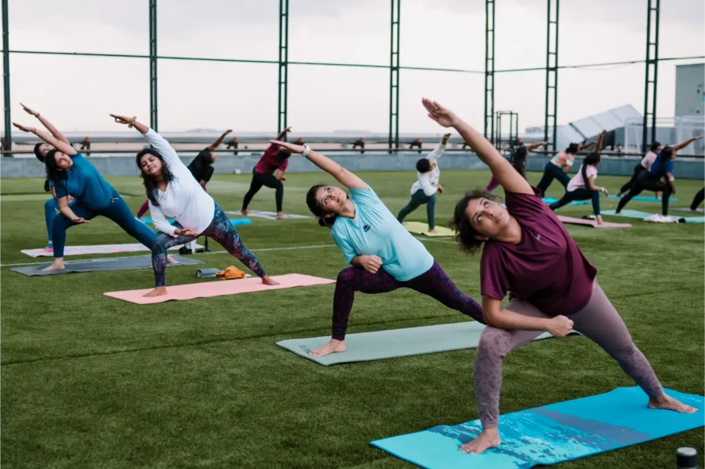 Why do many people prefer outdoor yoga sessions?